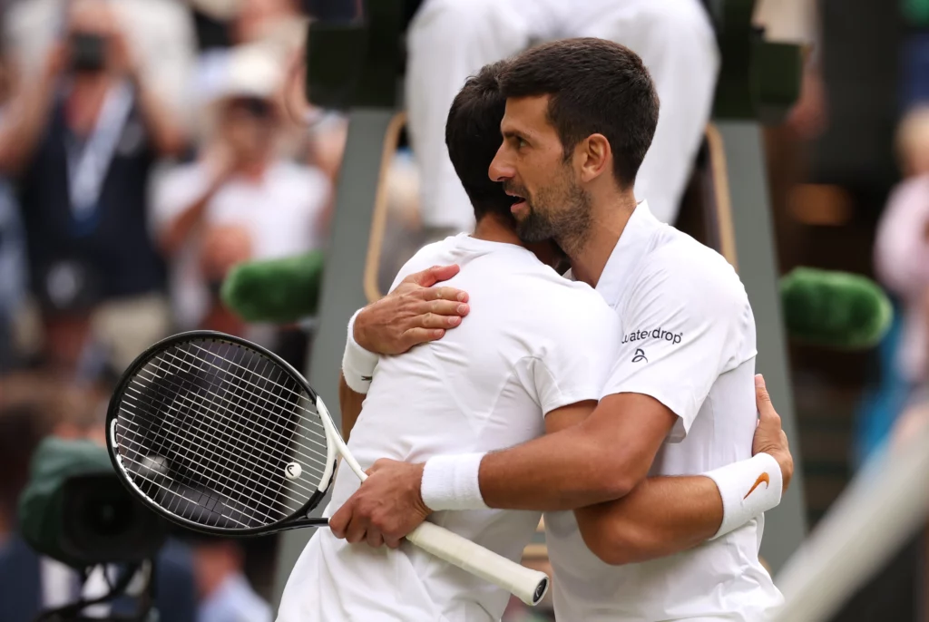 Novak Djokovic and Carlos Alcaraz hug after match