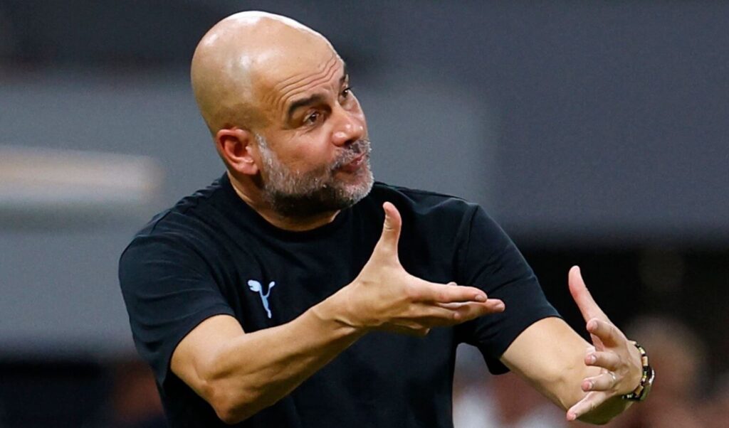Pep Guardiola, Manchester City's coach, offering directions during a football match.