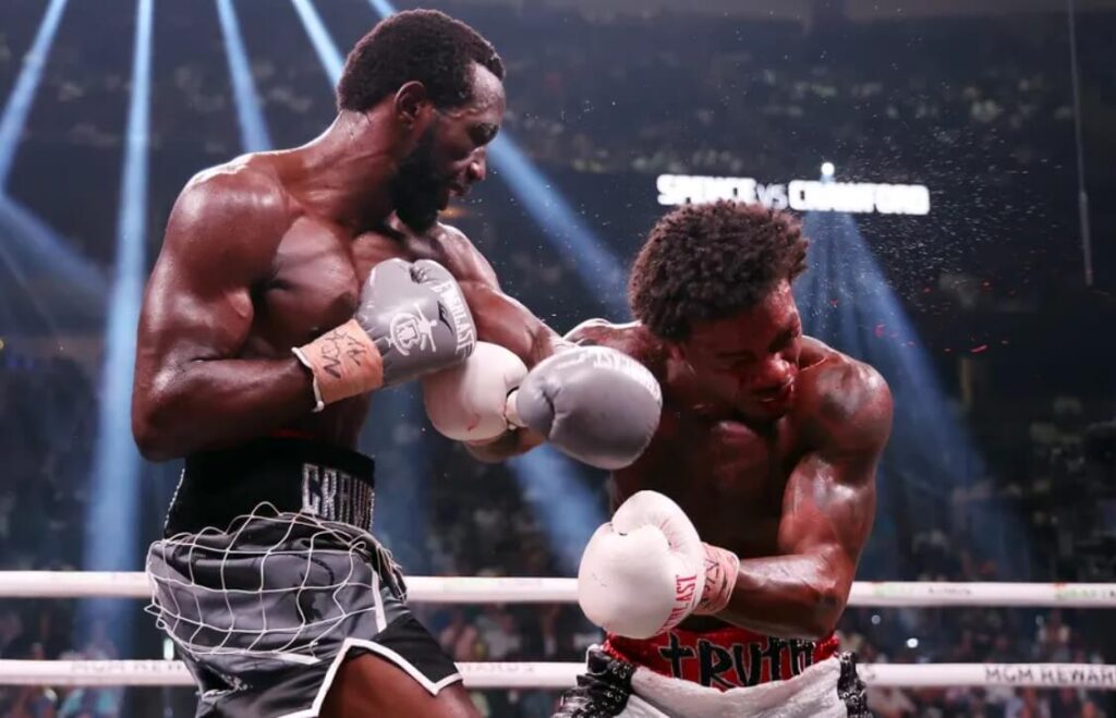 Snapshot of the intense moment as Crawford lands a punch on Spence Jr during their match.