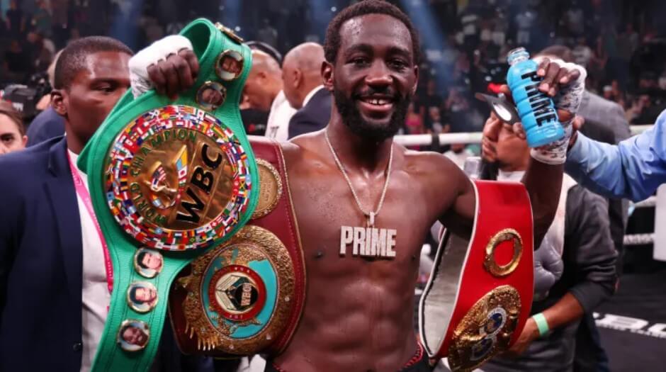 Terence Crawford proudly showcasing his championship belts after the fight.