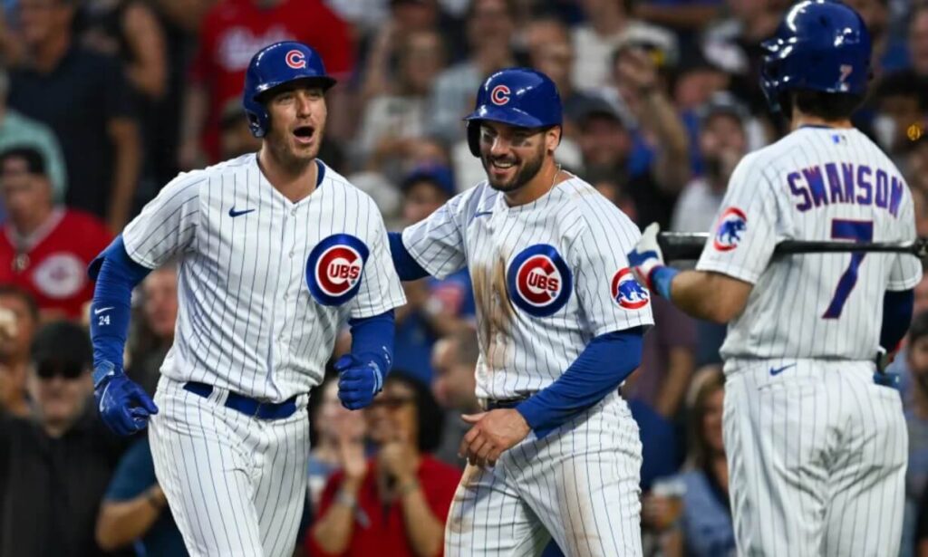 Members of the Chicago Cubs team sharing a celebratory moment after a run.