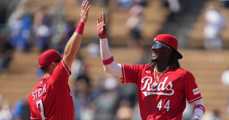 Cincinnati Reds team members sharing a camaraderie-filled moment on the field.