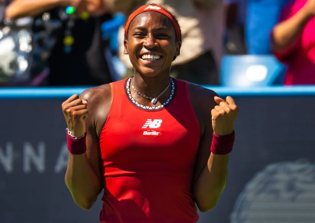 Coco Gauff celebrating a win on the court.