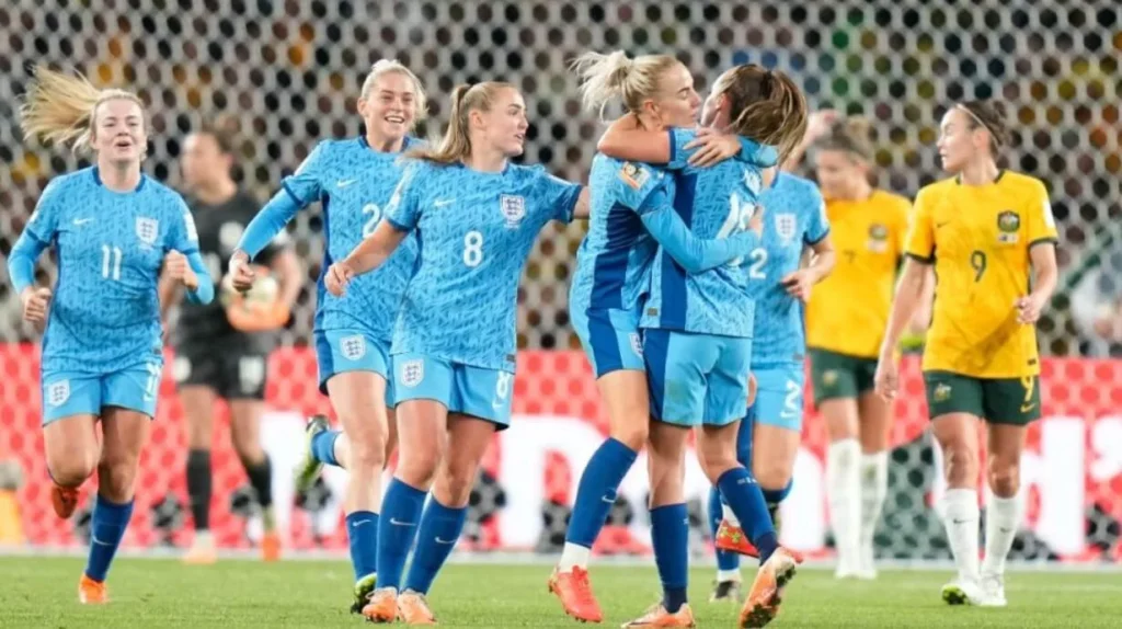 England team members rejoice as Ella Toone nets the initial goal for England during the Women's World Cup semifinal clash against Australia at Sydney's Stadium Australia.