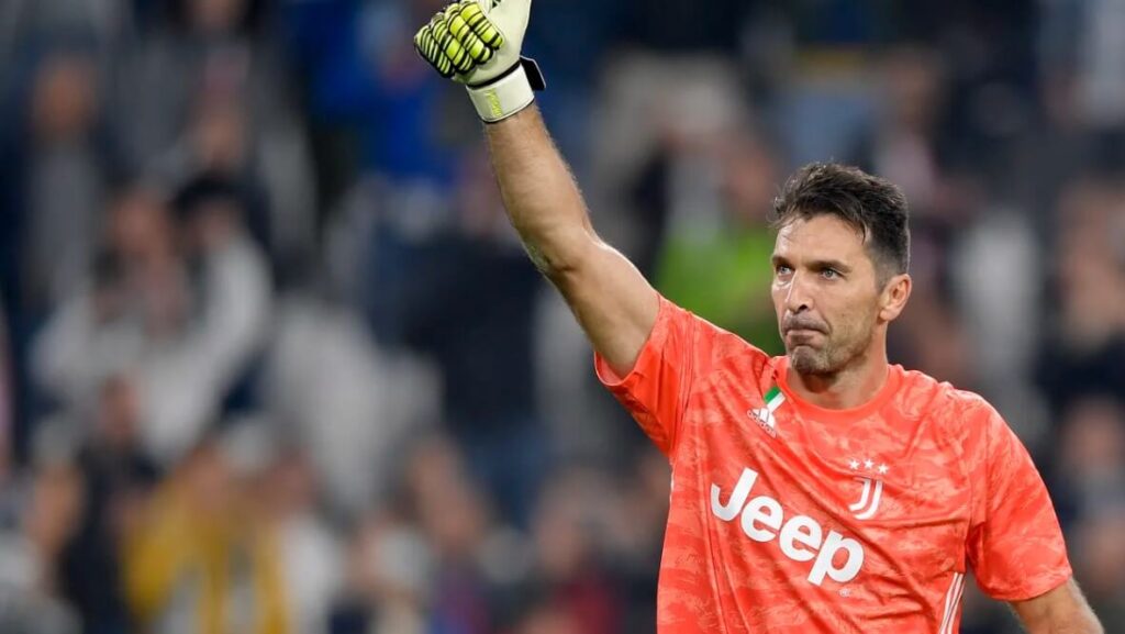 Gianluigi Buffon, wearing Juventus kit, in action on the football field.