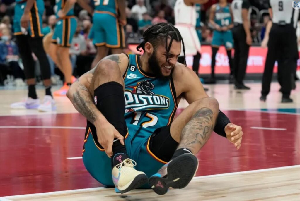 Basketball player Isaiah Livers visibly in pain after a sports injury.