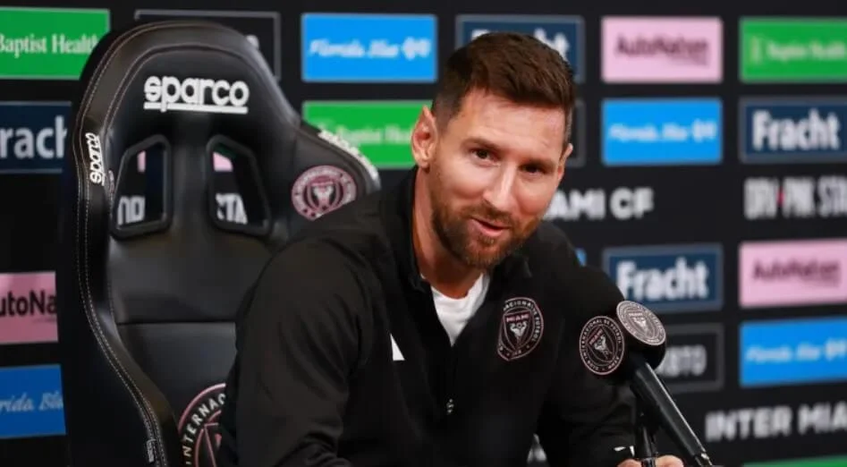 Lionel Messi speaking to journalists at a conference.