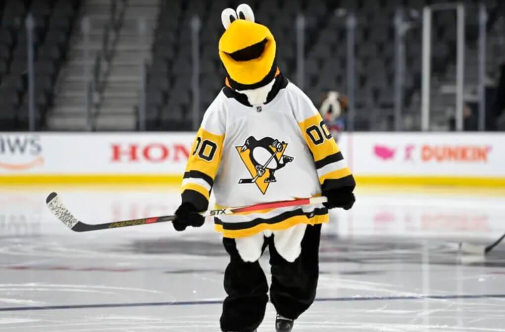 Full-length shot of the Penguins' mascot on home ice.