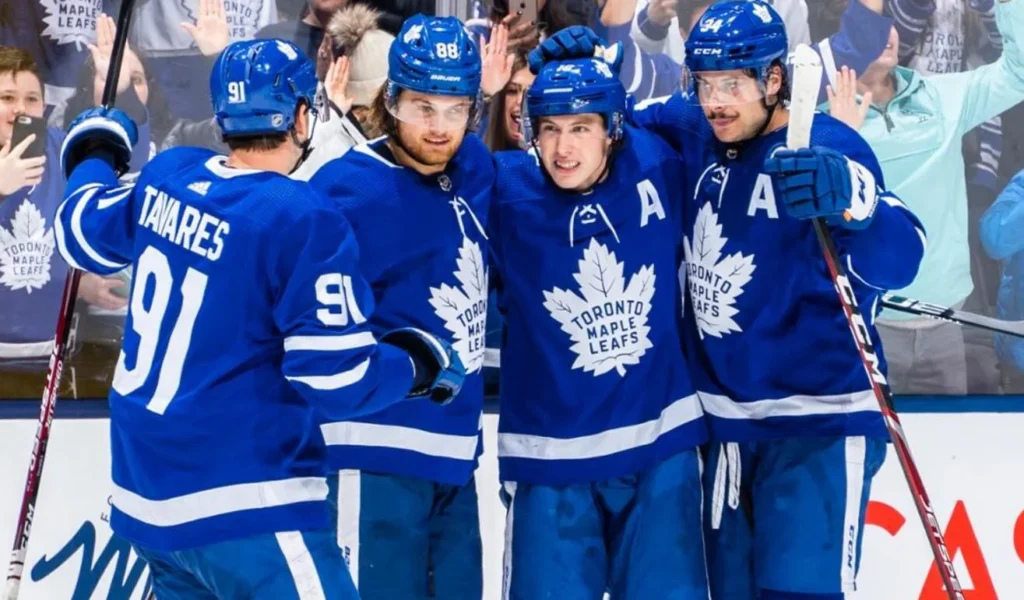 Maple Leafs teammates celebrating a goal together.