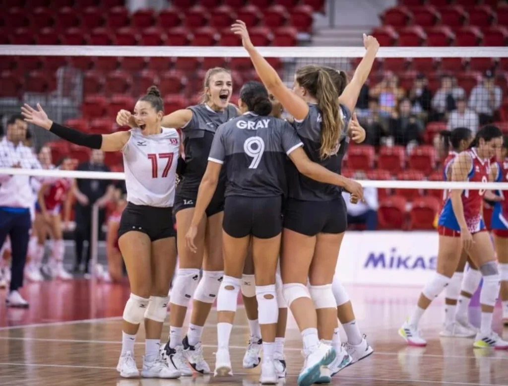 Victory elation: Canada's volleyball team sharing a celebratory moment.
